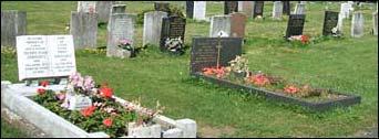 Graves in lawn area behind two gaves with kerbs in the foreground