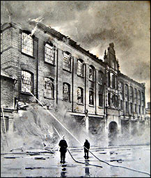 Firemen fighting the blaze at the front of the factory in the High Street