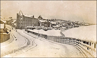 Picture postcard of the view from the High Street looking down Station Road.