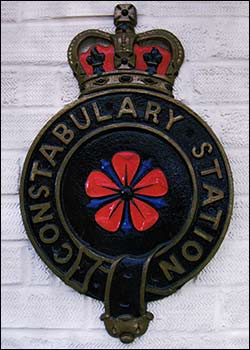 A badge from a Police House