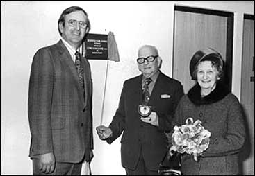 Photograph of cHead Teacher Bob Whitworth and Mr and Mrs Cyril Faulkner unveiling the plaque.
