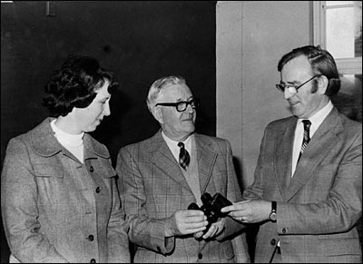 Photograph of Bob Whitworth being presented with binoculars