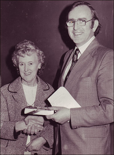 photograph ofBob Whitworth being presented with a pen 