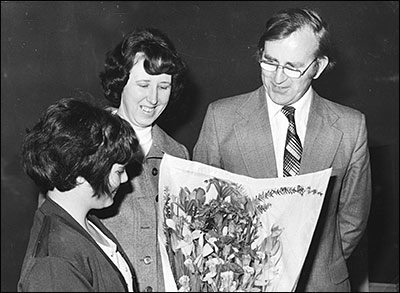photograph of Bob Whitworth and wife being presented with flowers