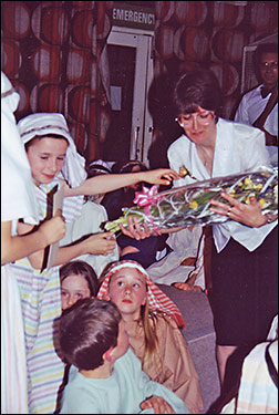 Photograph of Susan Manton presented with a bouquet.
