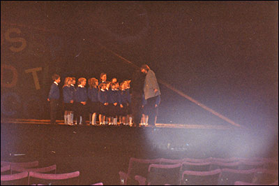 Photograph of director of the show talking to the Whitefriars choir