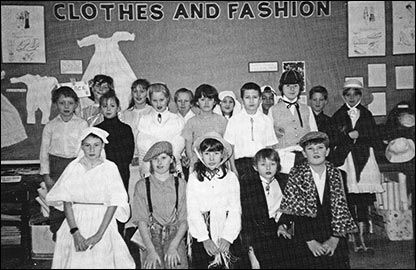 Classroom display and children dressed up for topic on Clothes and Fashion