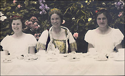 The Carnival Queen and two of her maids having tea