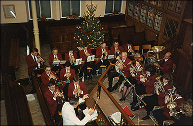 photo of Ray conducting a Christmas concert at one of the Mission Band venues