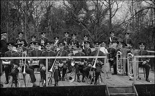 Photo of band sporting their new uniforms on the temporary band stand at Rushden Hall Park 1931.