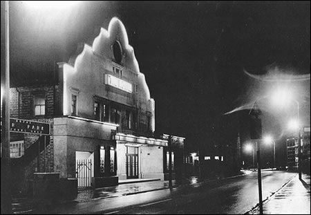 A floodlit photograph of the Theatre Cinema