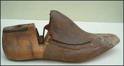 A shoe last with leather added to increase the size on top