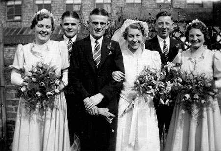 The bride & groome with thebridesmaids. Ada's father looking on proudly.