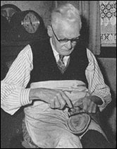 Horace Phillips hard at work hand-sewing shoes.