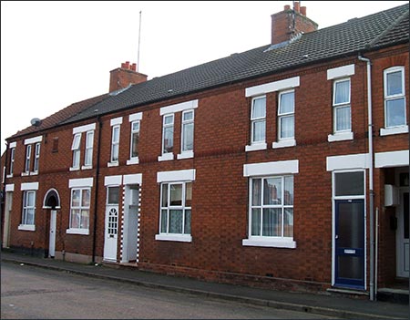 Note the row of tiles in line with the upper windows sills