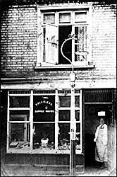 Rollie Cox's shop with him in the doorway