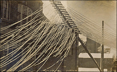 Picture postcard of damaged telegraph poles in Rectory Road.