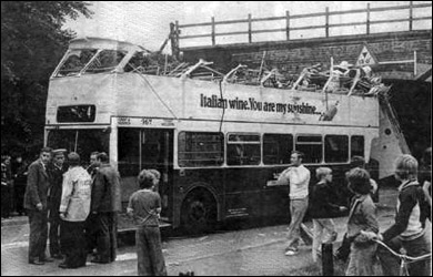 The top is sliced off the bus by the bridge!