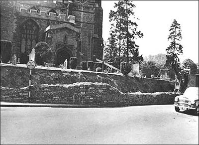 Churchyard wall being demolished