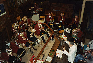 Photo of Ray conducting a Christmas concert at one of the Mission Band venues