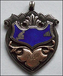 The front of the badge engraved A P