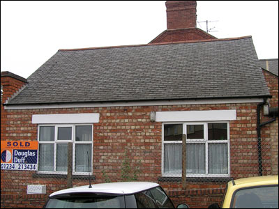 side of the tiny building