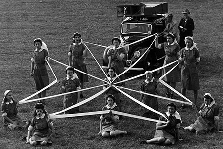 The cadets form their cross with white ribbons