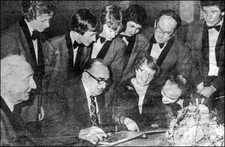 Bill looking at the scrapbook