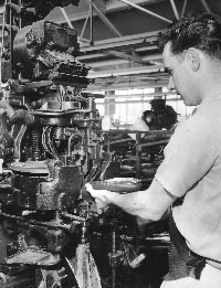 Man operating a heel seat lasting machine